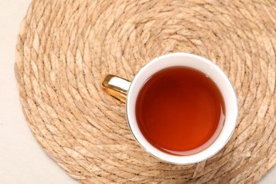 Photo of Aromatic tea in cup on table, top view