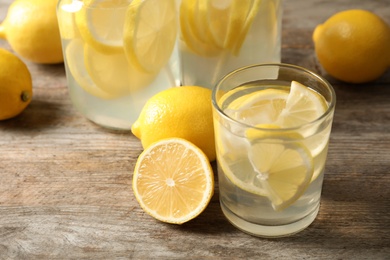 Natural lemonade in glassware on wooden table