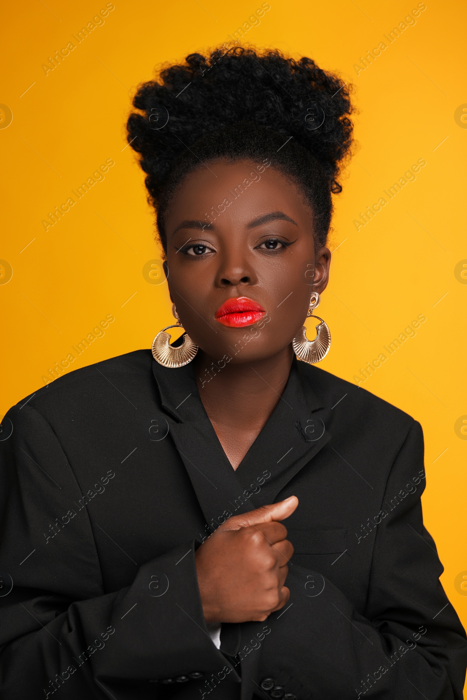 Photo of Fashionable portrait of beautiful woman on yellow background