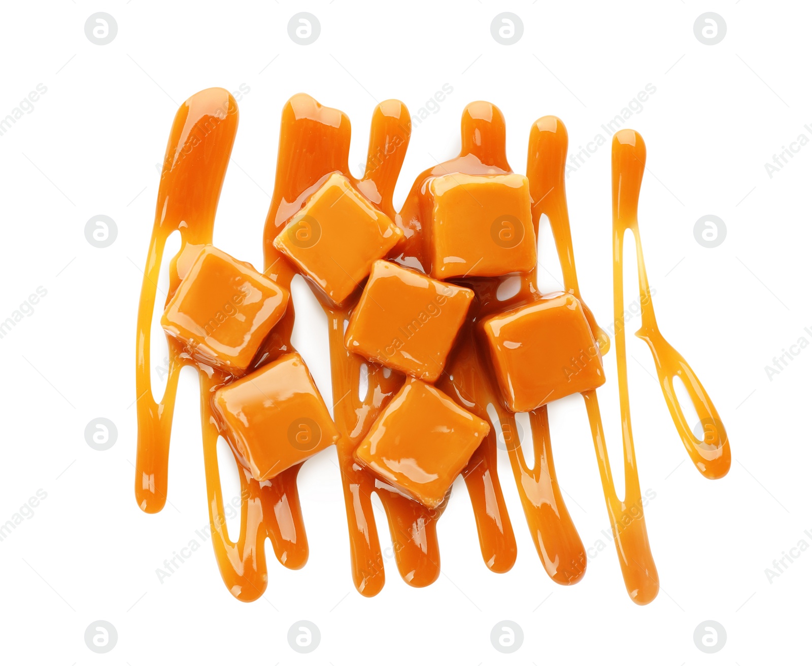 Photo of Heap of sweet caramel candies with topping isolated on white, top view