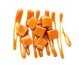 Photo of Heap of sweet caramel candies with topping isolated on white, top view