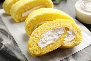 Delicious cake roll with cream filling on table, closeup