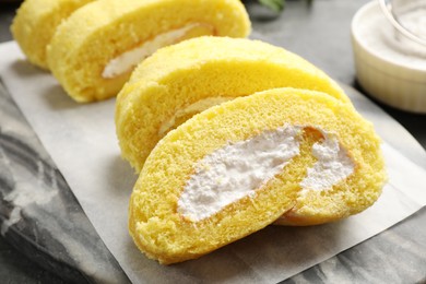 Photo of Delicious cake roll with cream filling on table, closeup