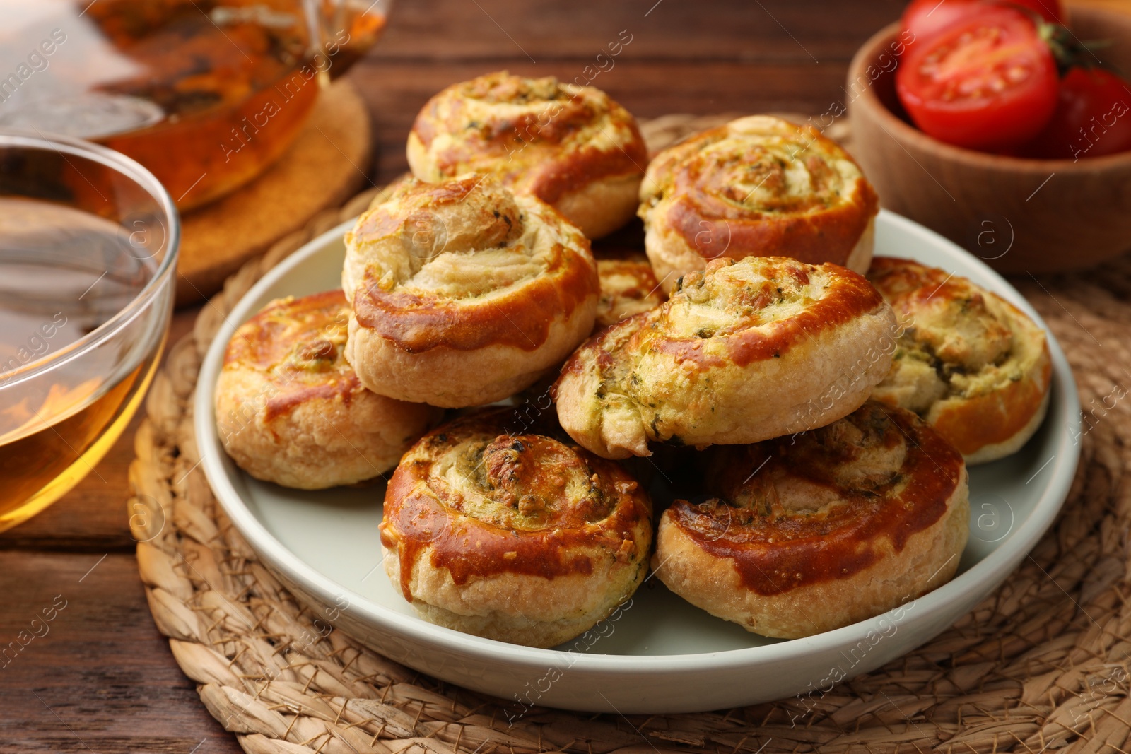 Photo of Fresh delicious puff pastry with tasty filling on wooden table, closeup