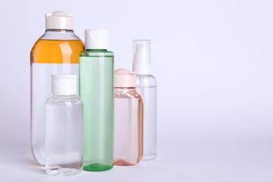 Photo of Bottles of micellar water on white background. Space for text