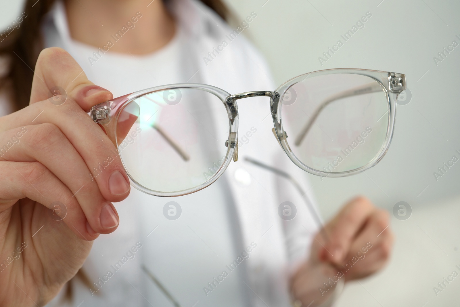 Photo of Woman with glasses on light background, closeup