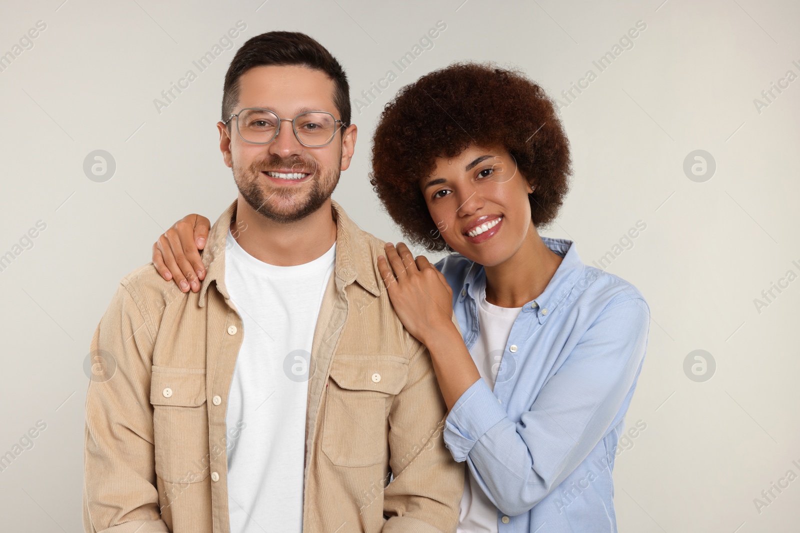 Photo of International dating. Portrait of happy couple on light grey background