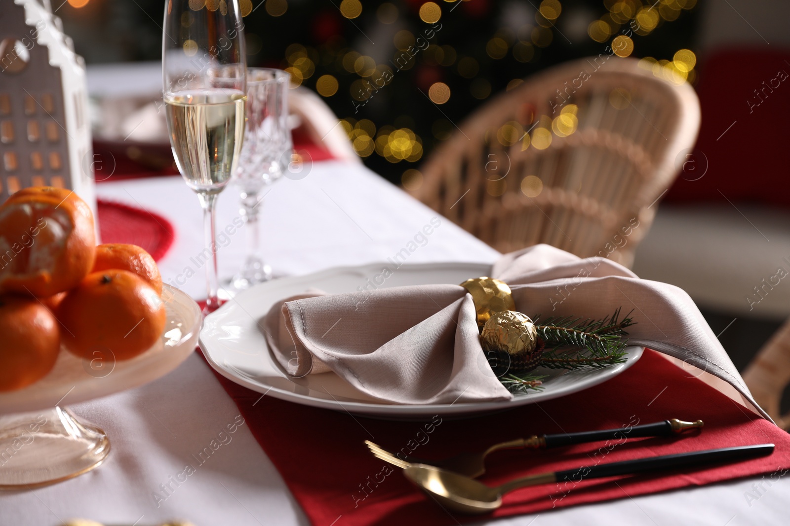 Photo of Christmas table setting with beautiful napkin, cutlery and dishware, closeup