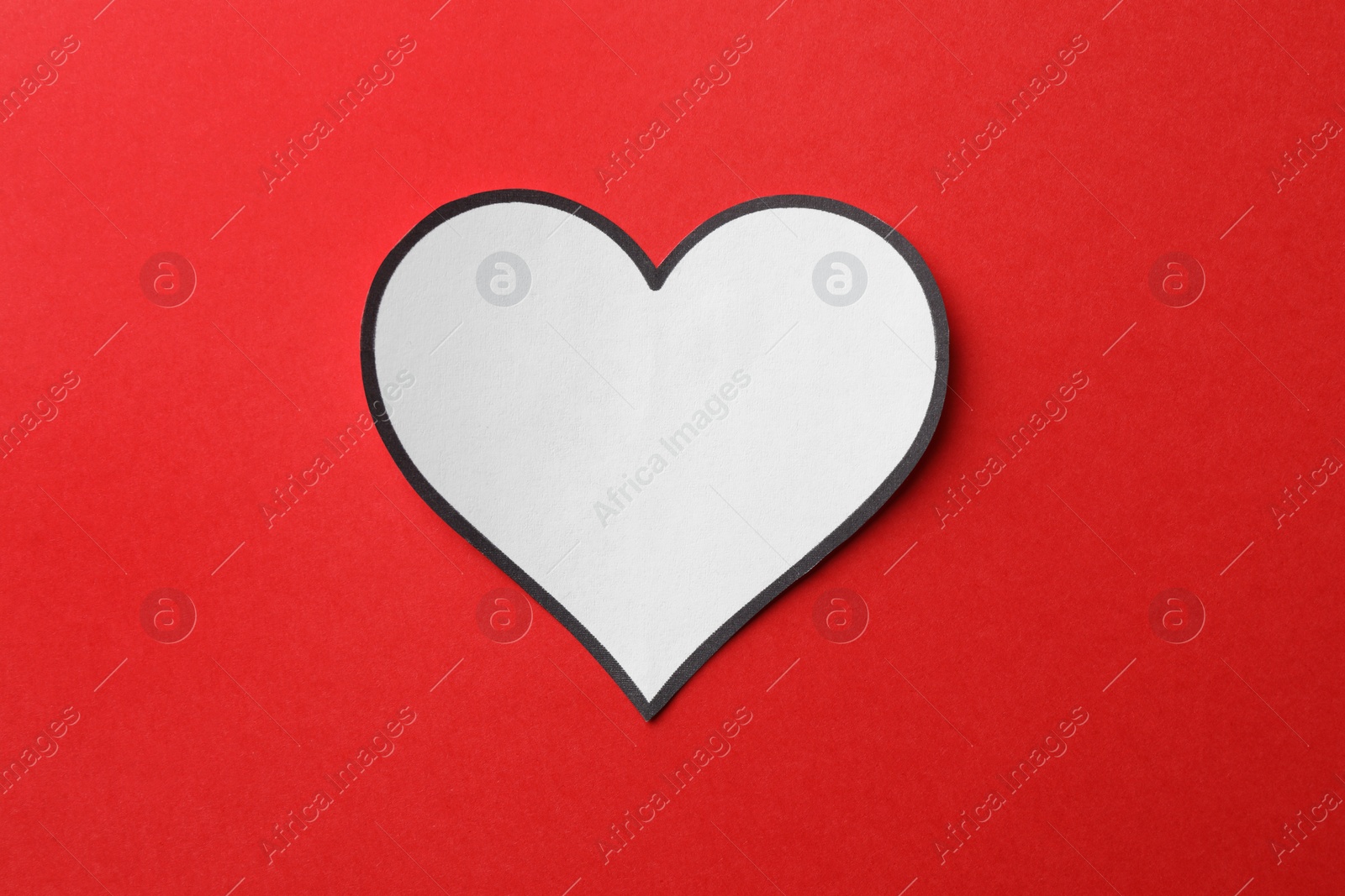 Photo of White paper heart on red background, top view