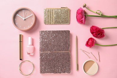 Photo of Flat lay composition with glittering notebook, cosmetics and spring flowers on color background