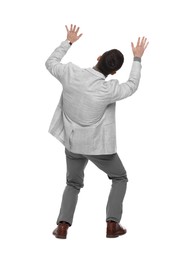 Businessman in suit evading something on white background, back view