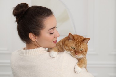 Photo of Beautiful woman with cute cat at home