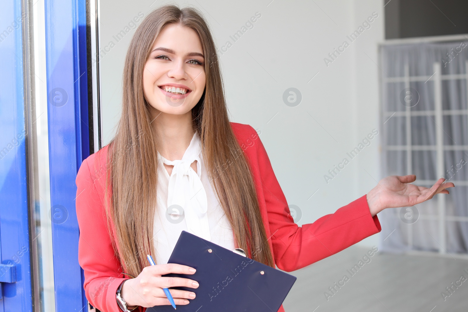 Photo of Beautiful real estate agent with clipboard outdoors