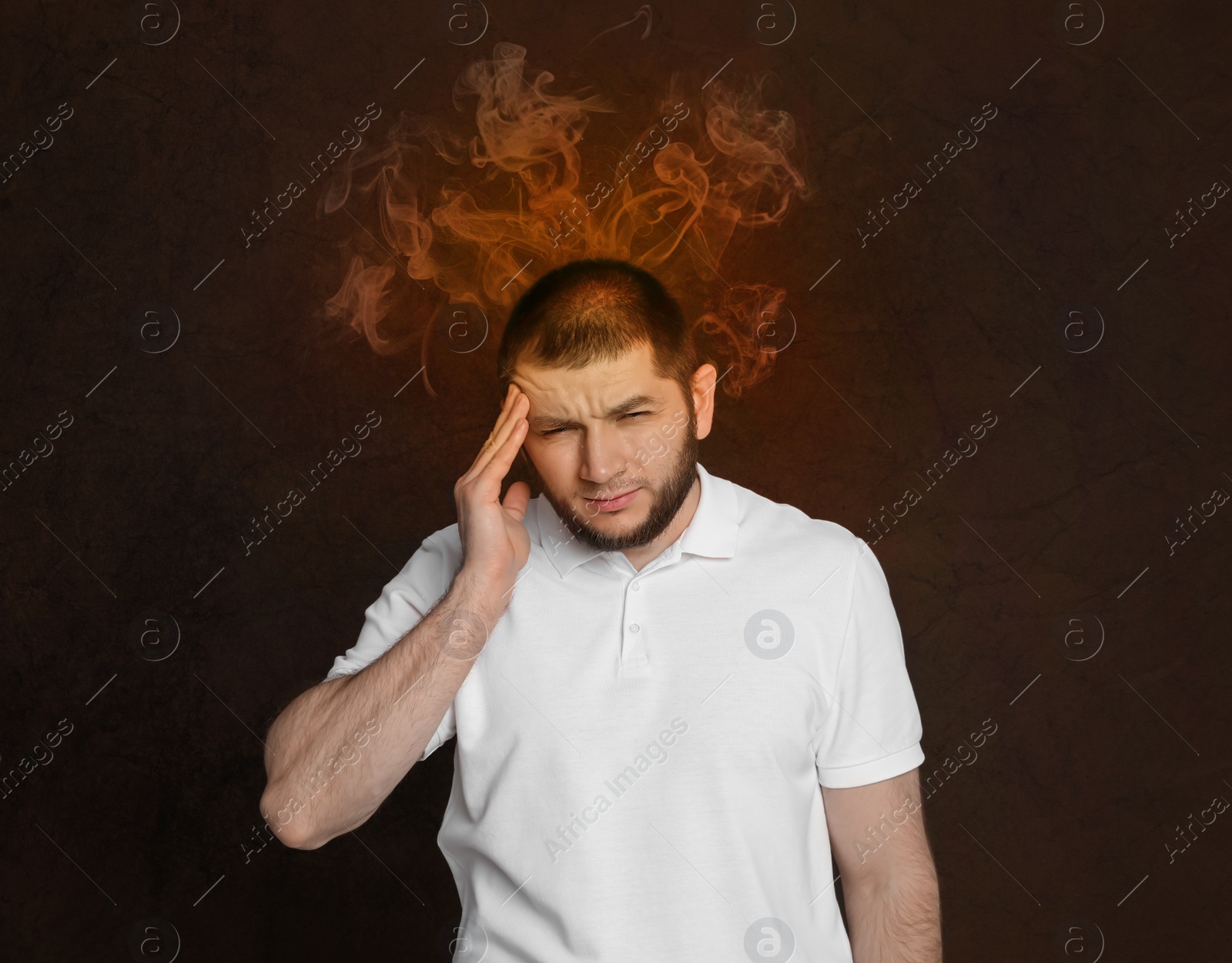 Image of Man having headache on brown background. Illustration of fire representing severe pain