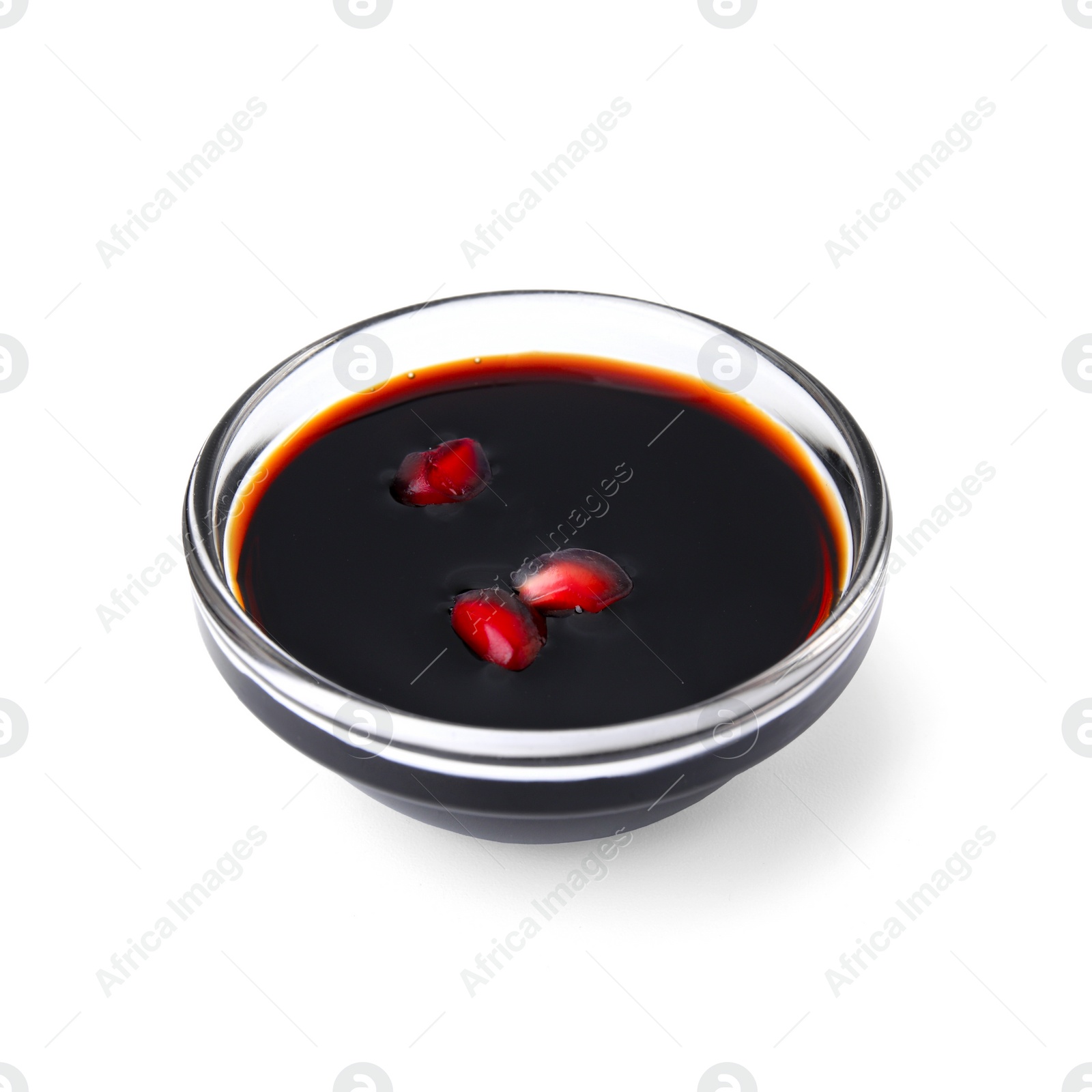 Photo of Tasty pomegranate sauce with seeds in bowl isolated on white