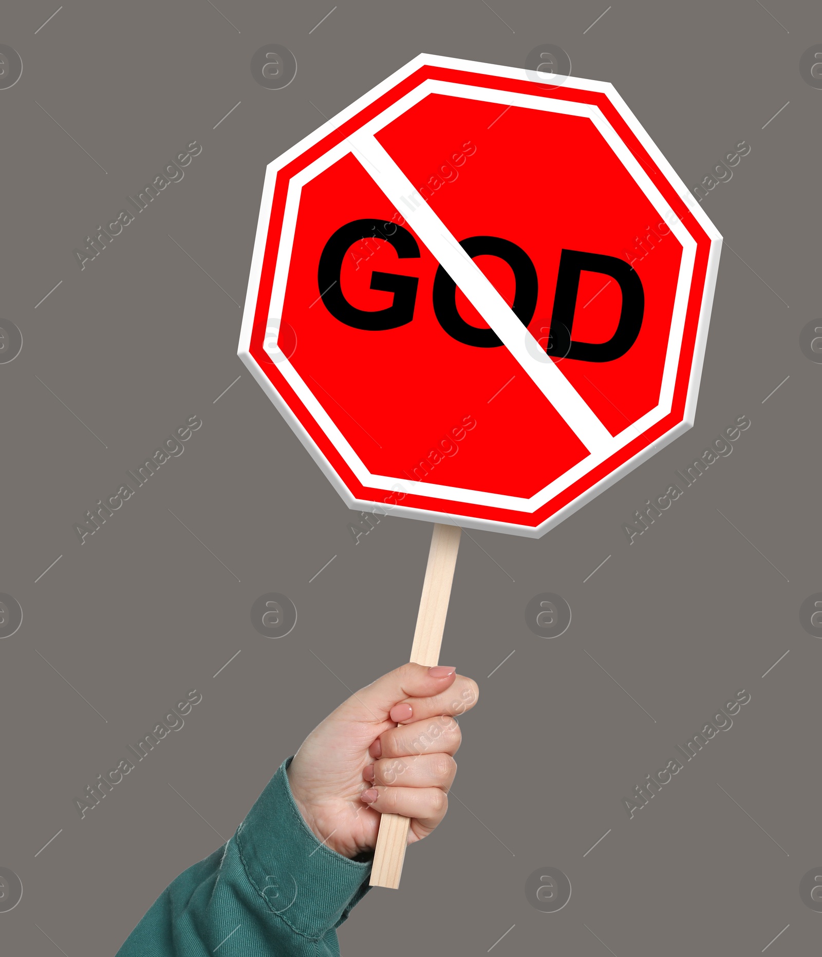 Image of Atheism concept. Woman holding prohibition sign with crossed out word God on color background