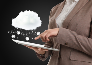 Cloud computing and storage concept. Woman using tablet on black background, closeup