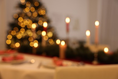 Photo of Blurred view of festive table setting and beautiful Christmas decor indoors. Interior design