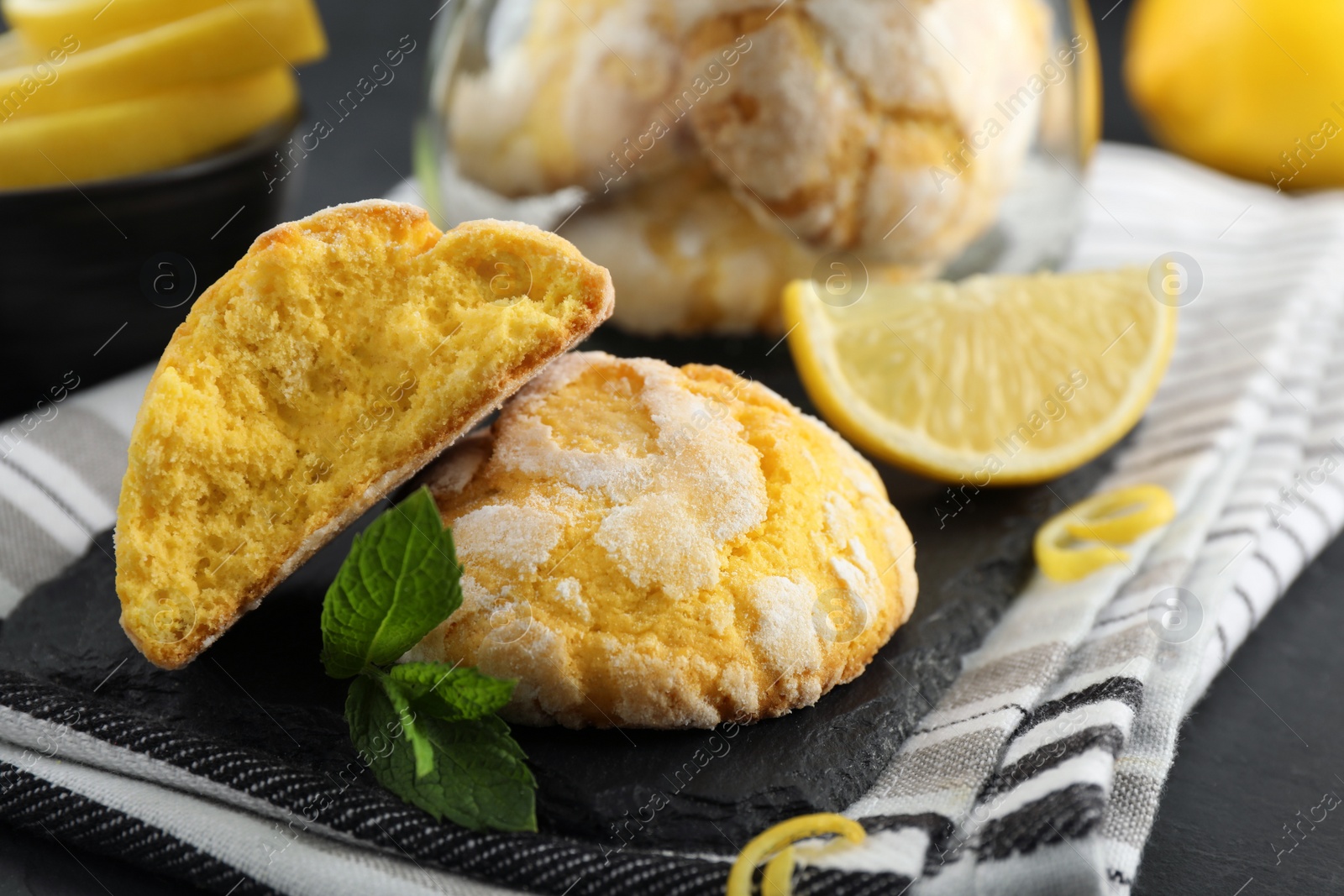 Photo of Delicious lemon cookies and mint on towel, closeup