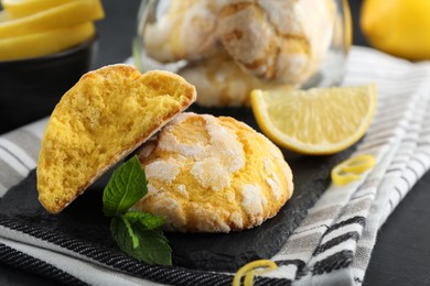 Photo of Delicious lemon cookies and mint on towel, closeup