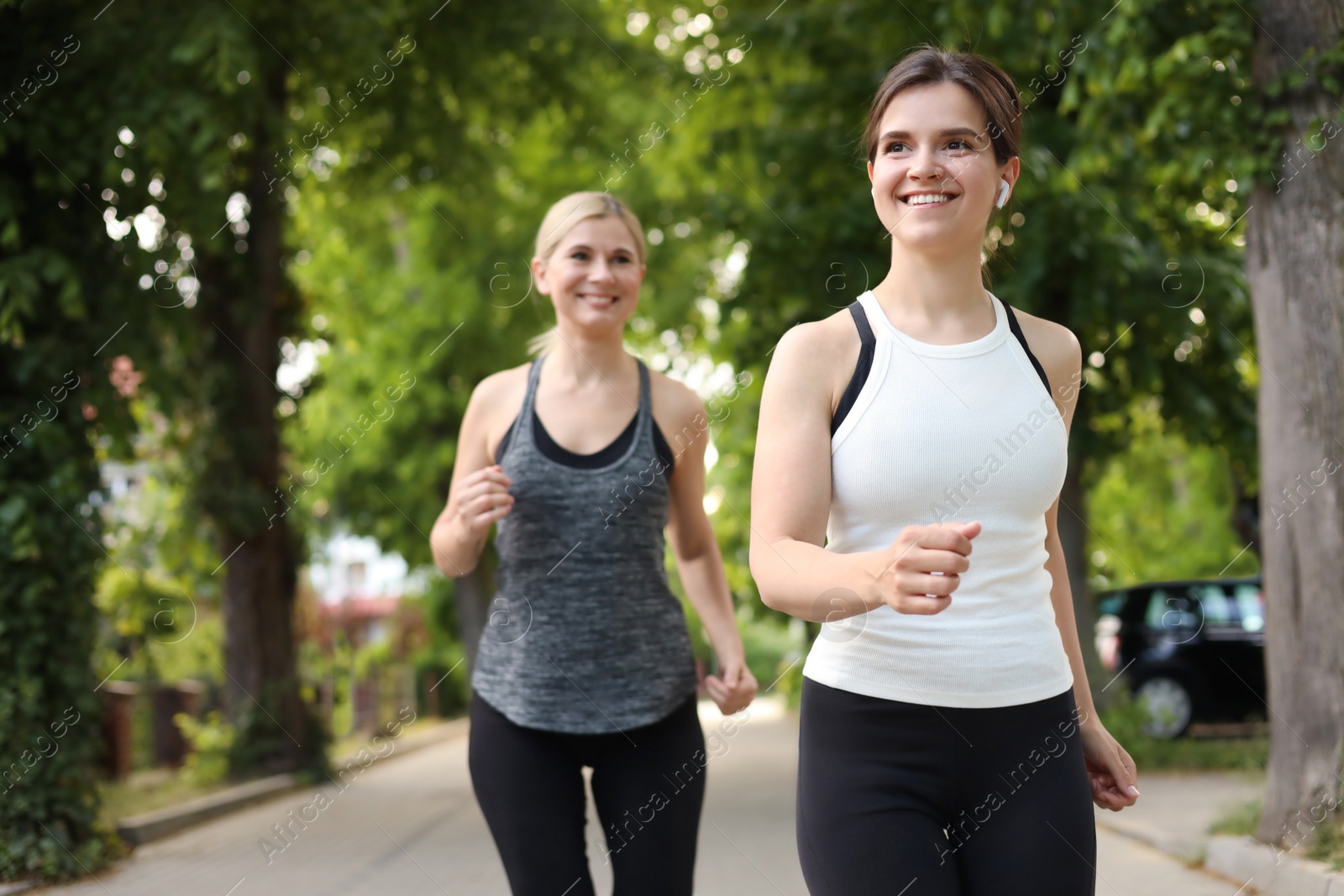 Photo of Women running on city street in morning