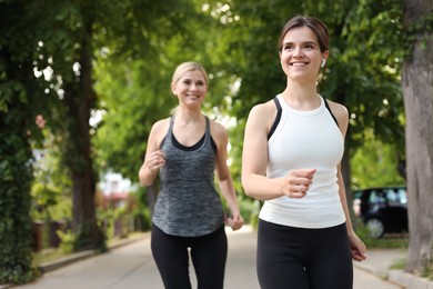 Women running on city street in morning