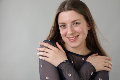 Photo of Portrait of beautiful young woman on grey background