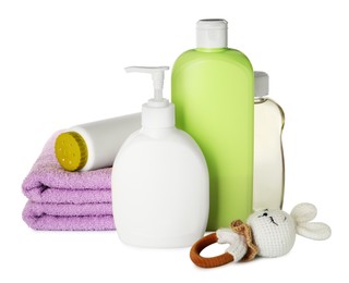 Photo of Bottles of baby cosmetic products, towels and toy on white background