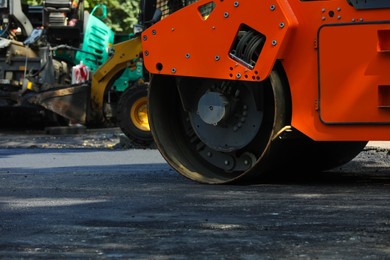 Photo of Modern roller on city street, closeup. Road repair service