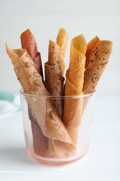 Delicious fruit leather rolls on white wooden table