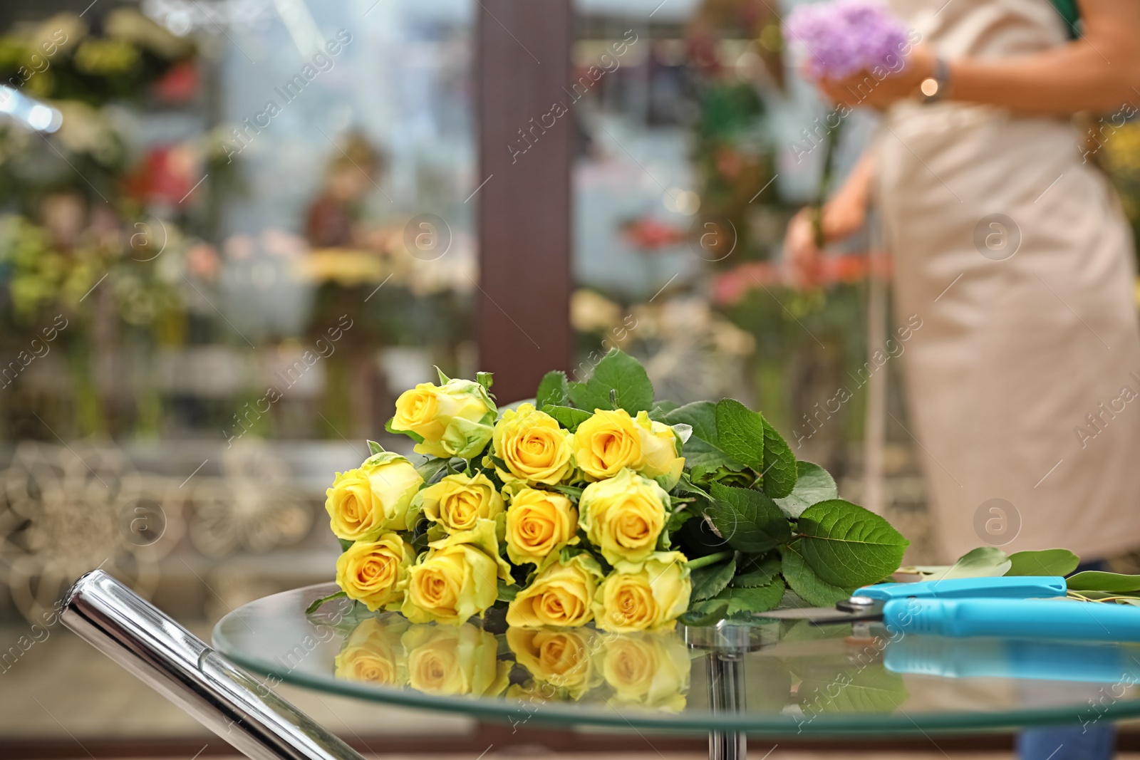 Photo of Beautiful bouquet on table in flower shop. Florist's workplace