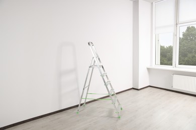 Photo of Stepladder near white wall in empty room
