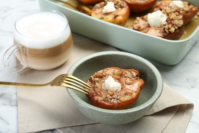 Photo of Tasty baked quinces with nuts and cream cheese served on table