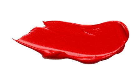 Photo of Red oil paint stroke on white background, top view