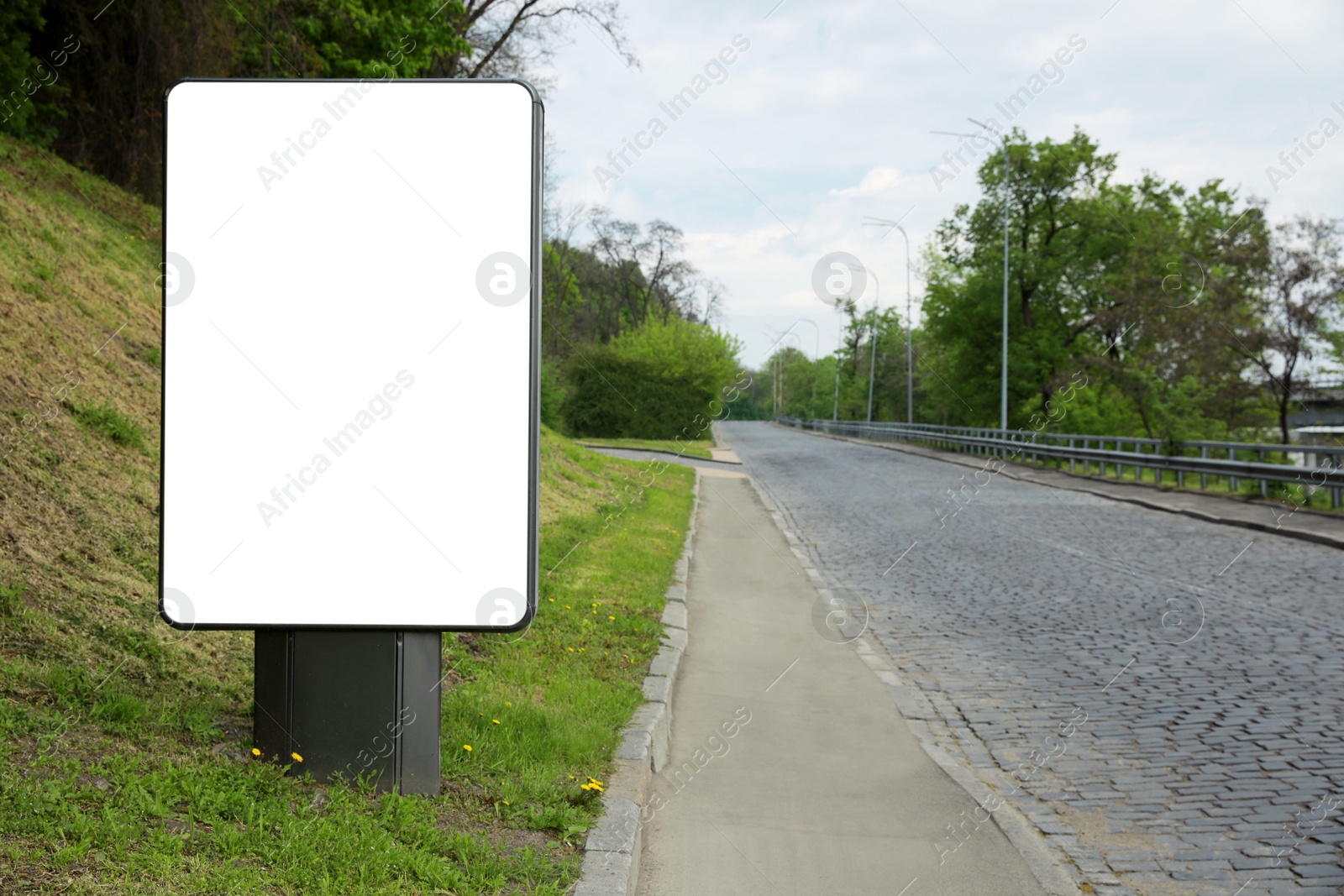 Photo of Blank advertising board on city street. Mockup for design