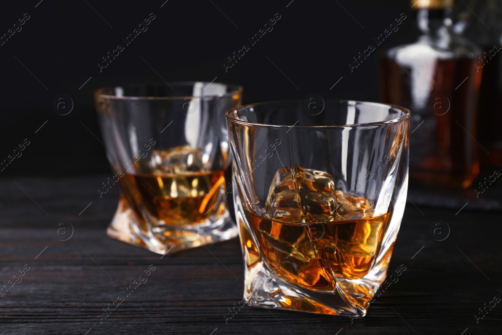 Photo of Composition with glass of whiskey on table