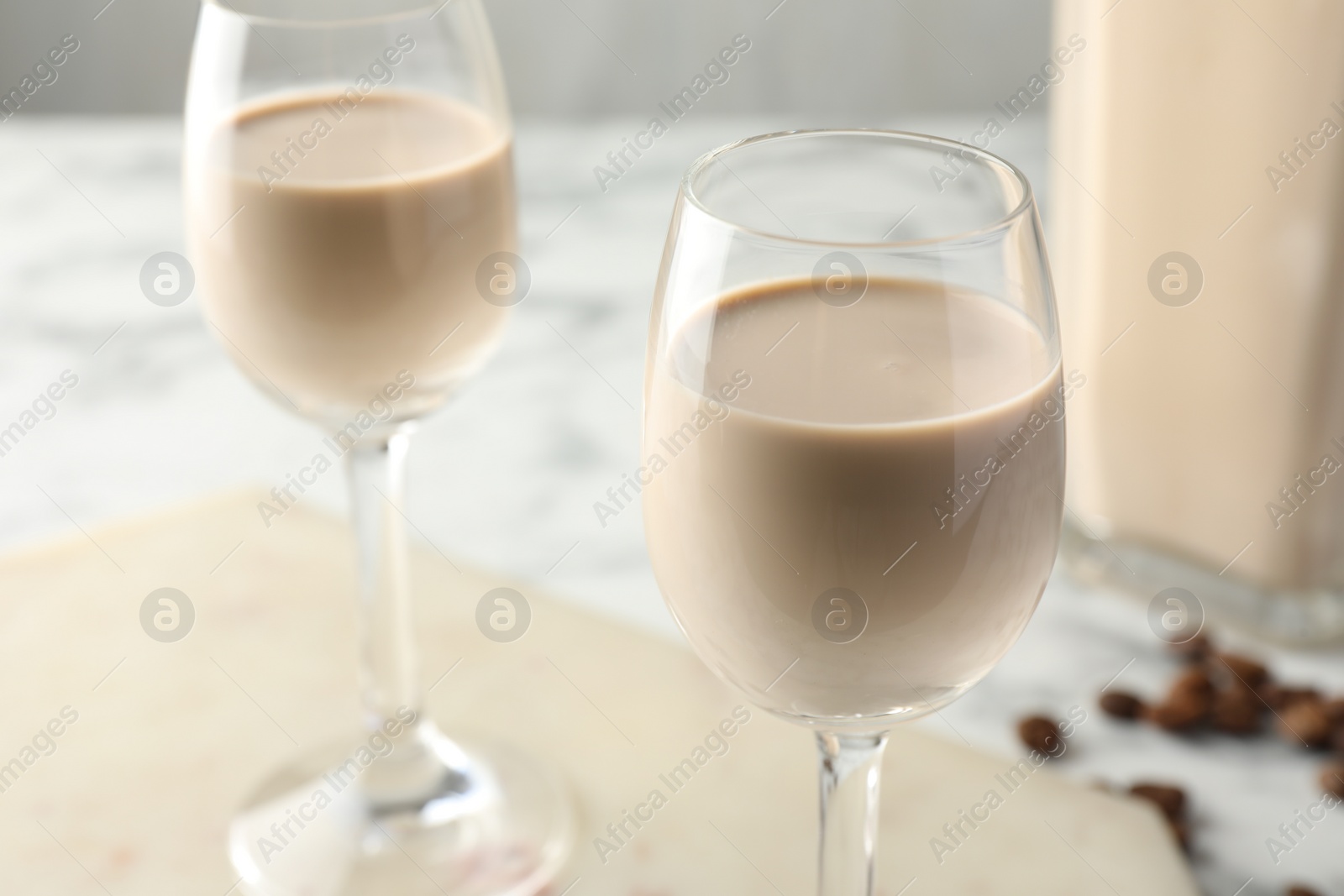 Photo of Coffee cream liqueur in glasses on table, closeup