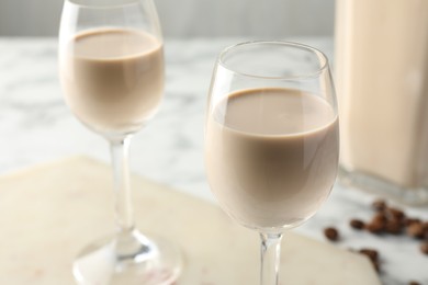 Coffee cream liqueur in glasses on table, closeup