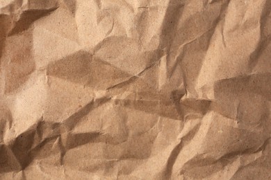 Sheet of crumpled kraft paper as background, top view