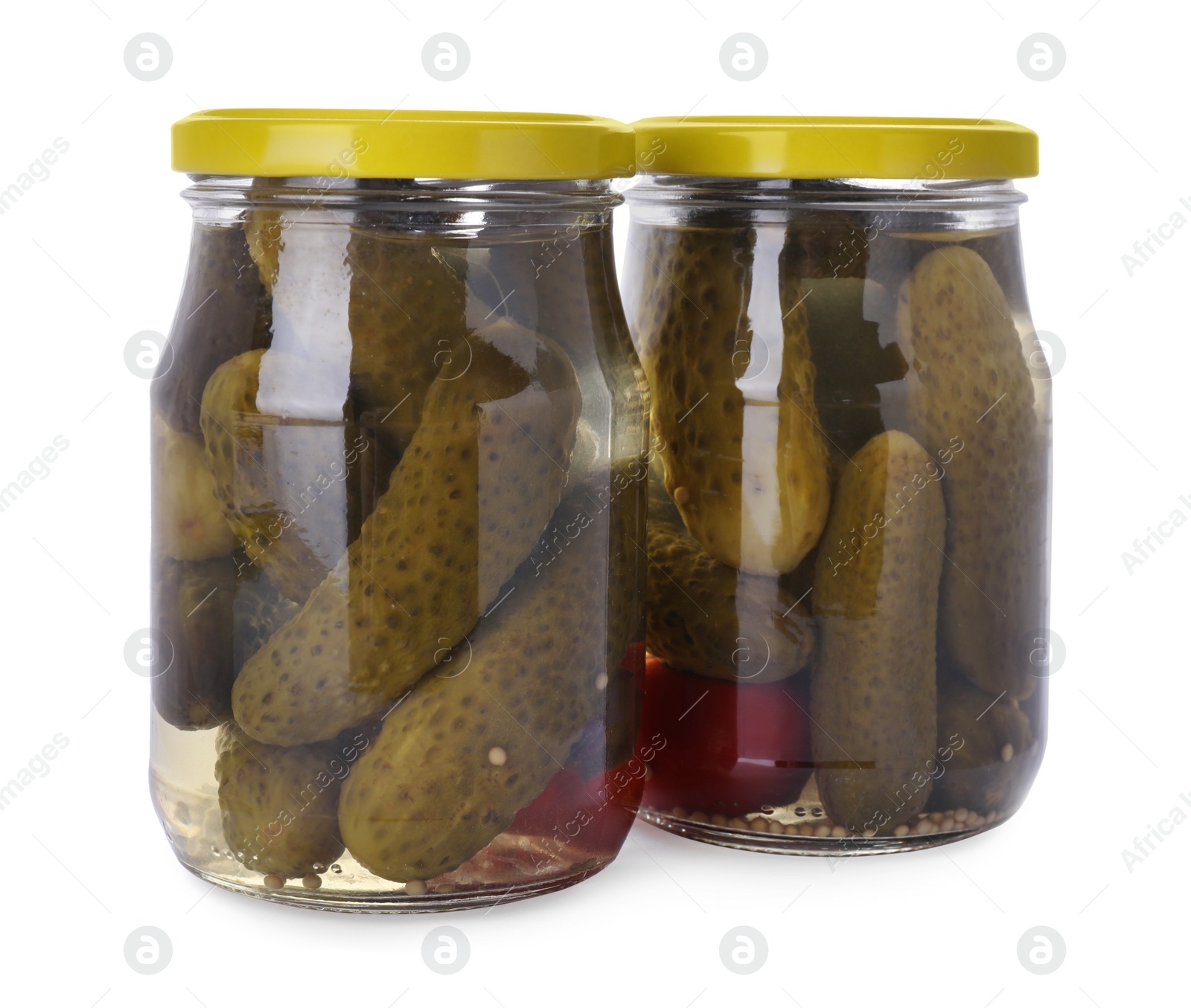 Photo of Jars of tasty pickled cucumbers isolated on white