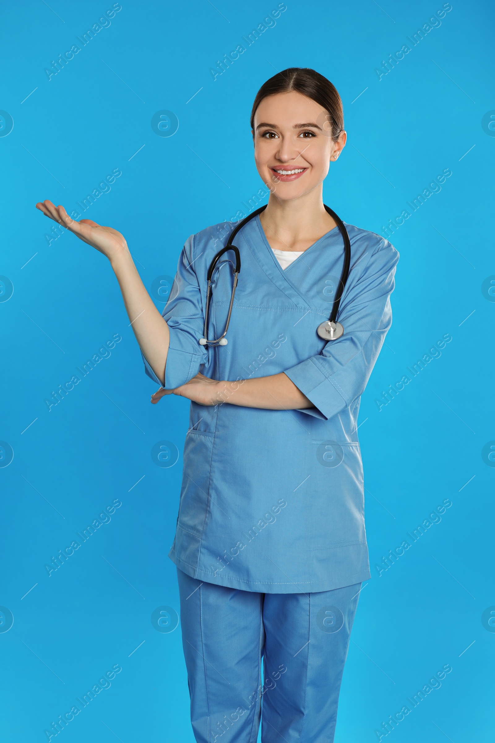 Photo of Portrait of doctor with stethoscope on blue background