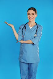 Portrait of doctor with stethoscope on blue background