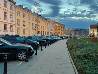 Cityscape with cars parked along street in evening