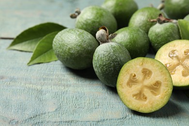 Fresh green feijoa fruits on blue wooden table, closeup