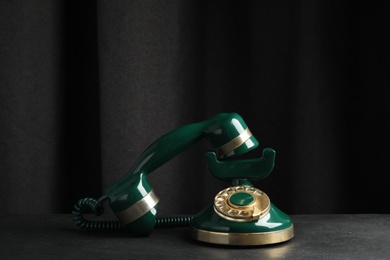 Photo of Vintage corded phone on black stone table