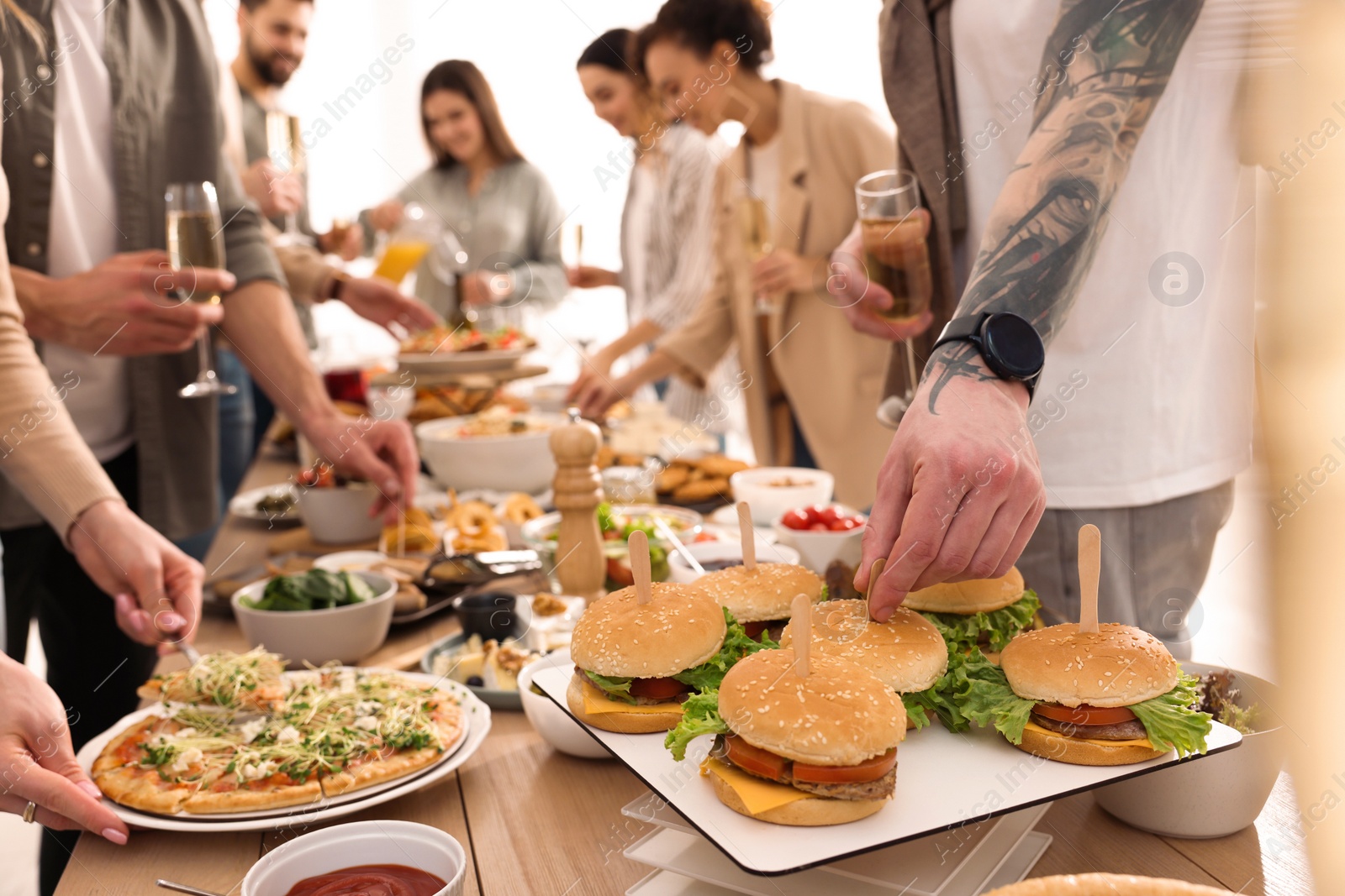 Photo of People near buffet table with food indoors, closeup. Brunch setting