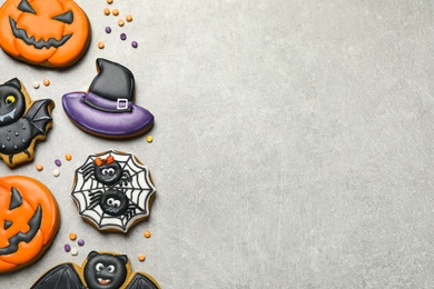Tasty Halloween cookies on light grey table, flat lay. Space for text