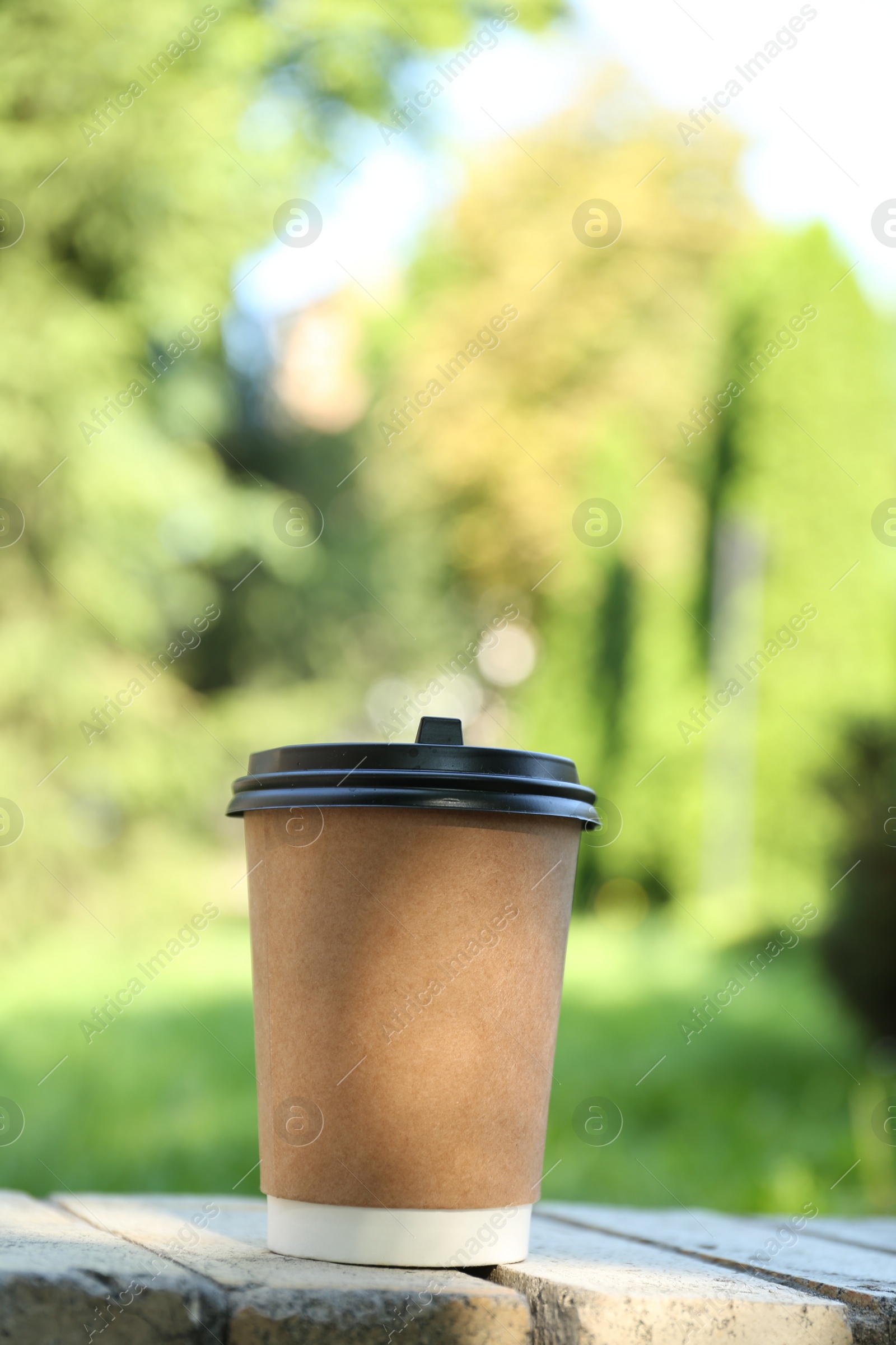 Photo of Paper cup on street outdoors. Takeaway drink