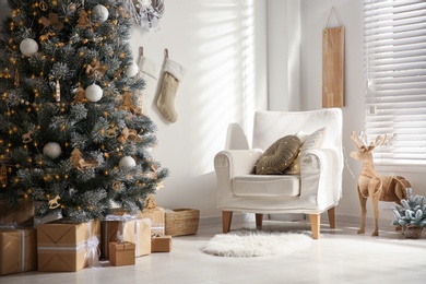 Beautiful decorated Christmas tree in festive room interior