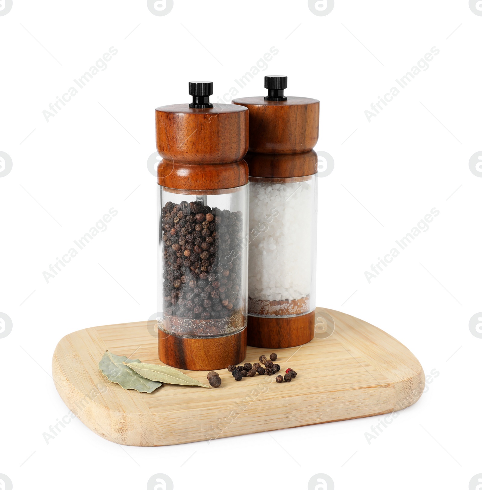 Photo of Salt and pepper shakers with bay leaves isolated on white